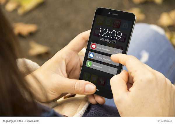 connectivity concept: woman holding a 3d generated smartphone with notifications on the screen. Graphics on screen are made up.